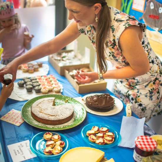 teacher handing a cake to a student