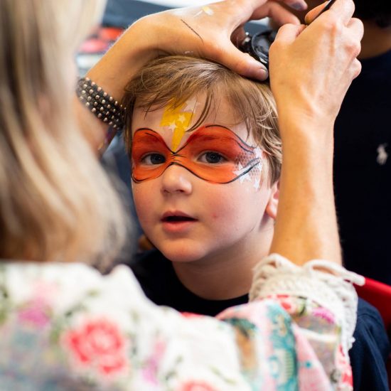boy having his face painted