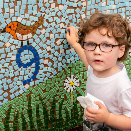 child looking at a mosaic