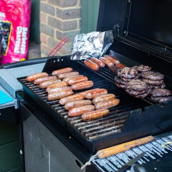 sausages and burgers on a large bbq