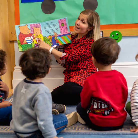 teacher pointing to a picture book