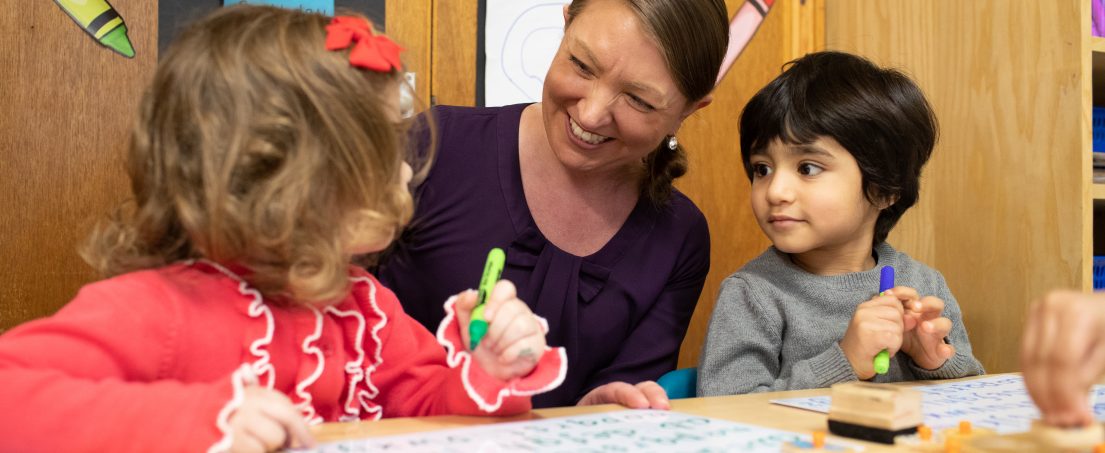 teacher looking after 2 students