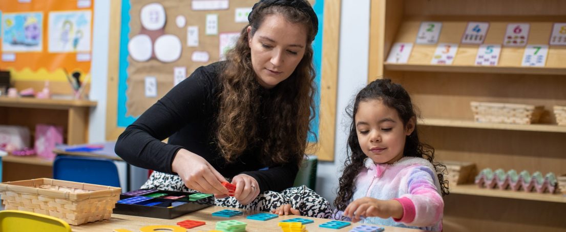 girl and teacher working on a maths game