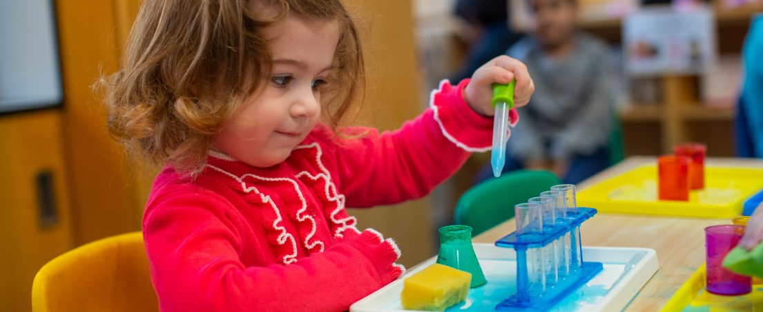 girl using test tubes and pipettes