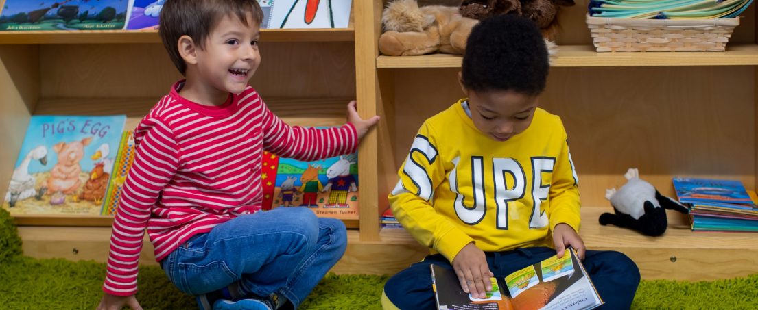 2 boys in the reading area of the school