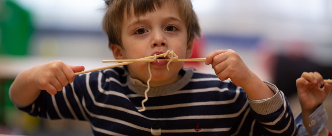Child eating noodles