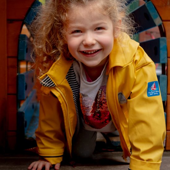 girl crawling through a small tunnel