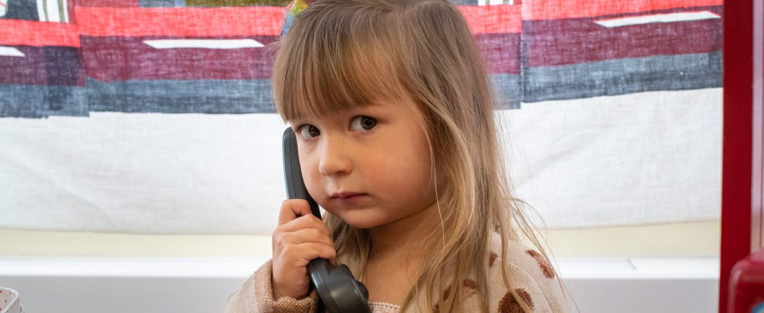 child holding phone