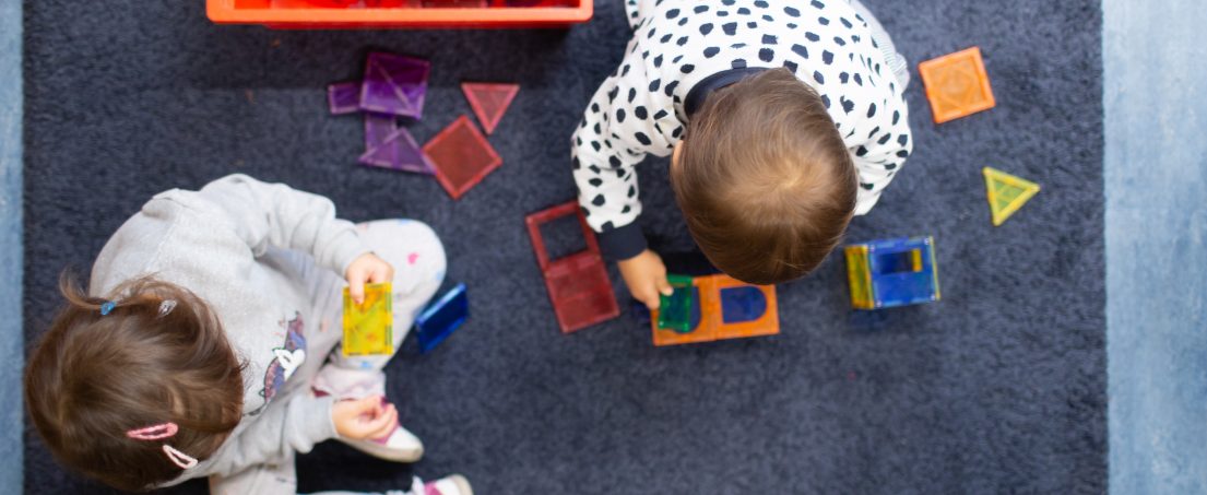 children building with pieces of plastic